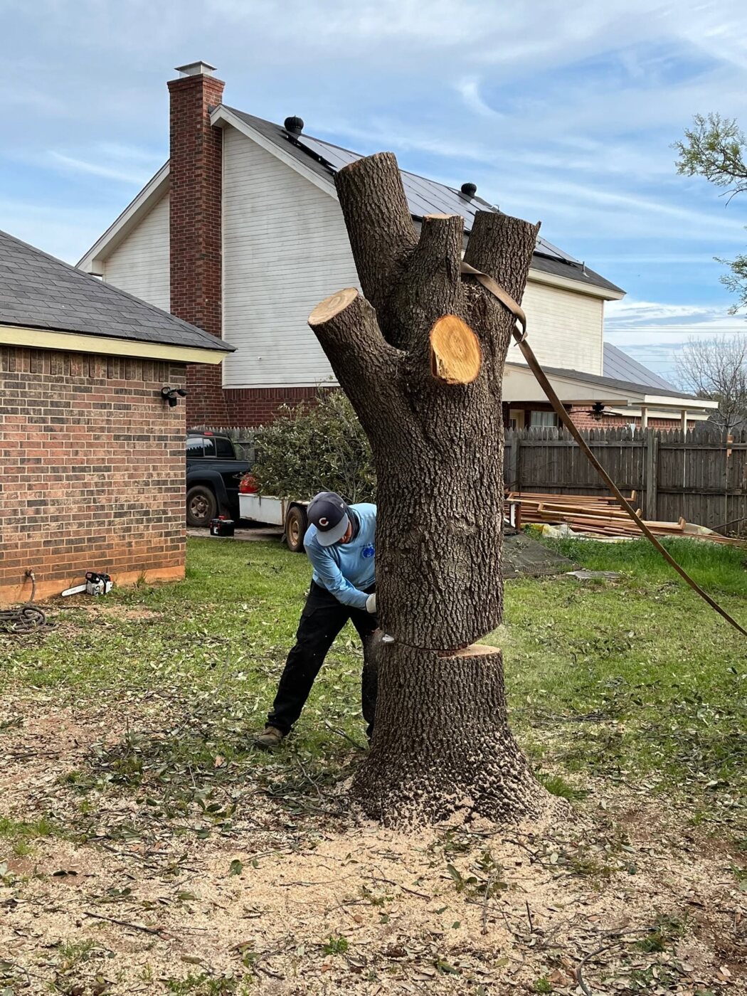 Karl Lipscomb safely cutting down a large tree section